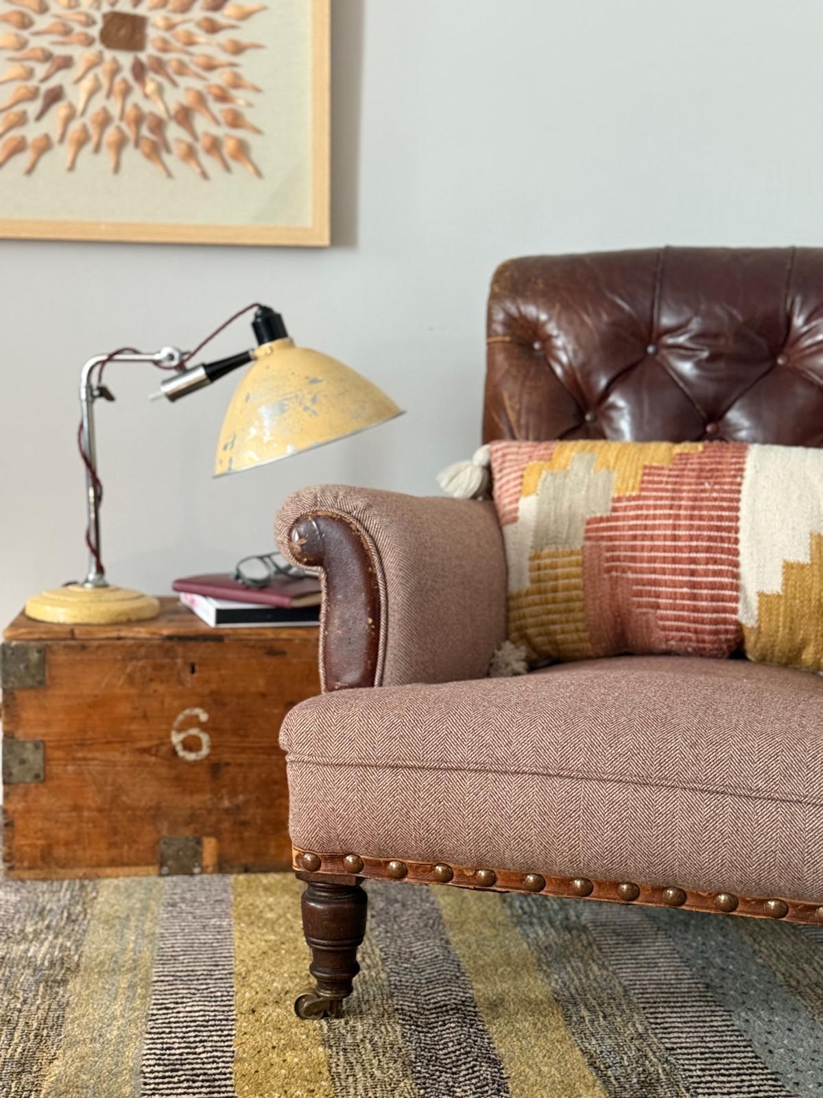 Reupholstered leather armchair, vintage lamp, wooden trunk, North Wales