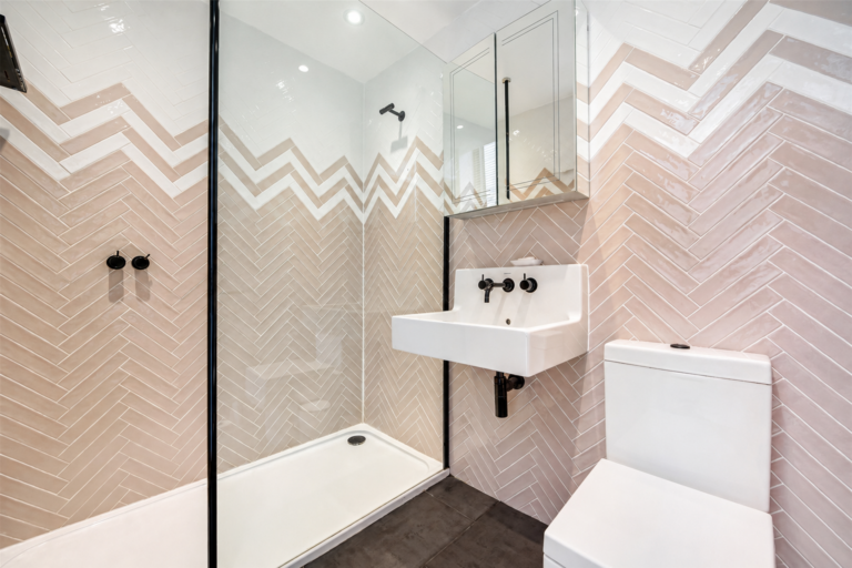 Chevron feature tiling for ensuite . Vola taps, Duravit sink and WC, Stockport